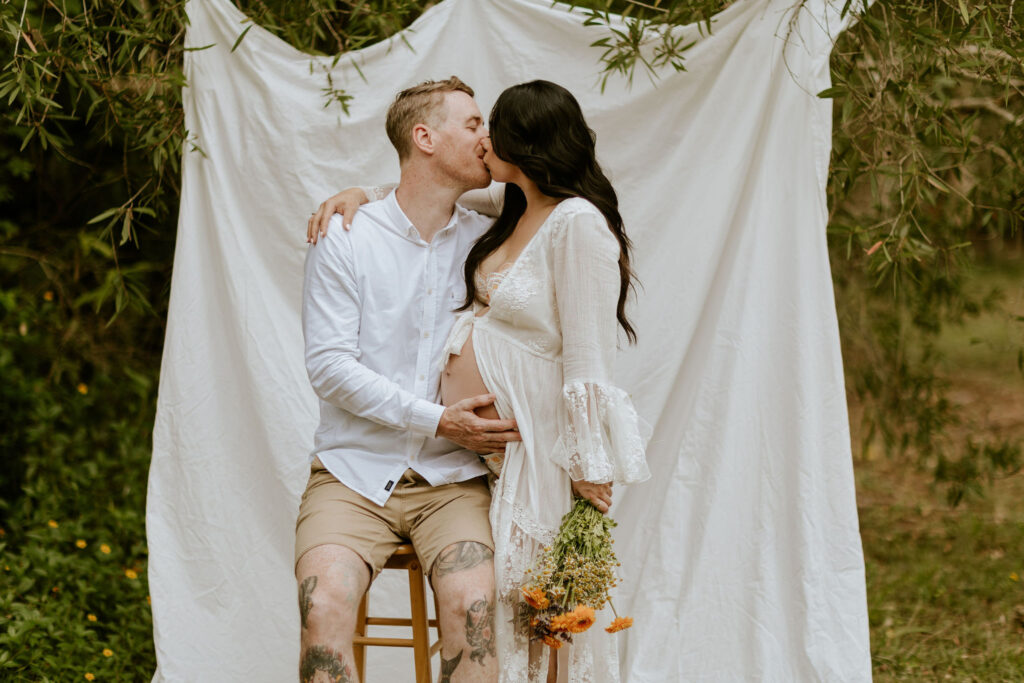 Backyard maternity photoshoot Brisbane featuring mum in flowing robe from client wardrobe