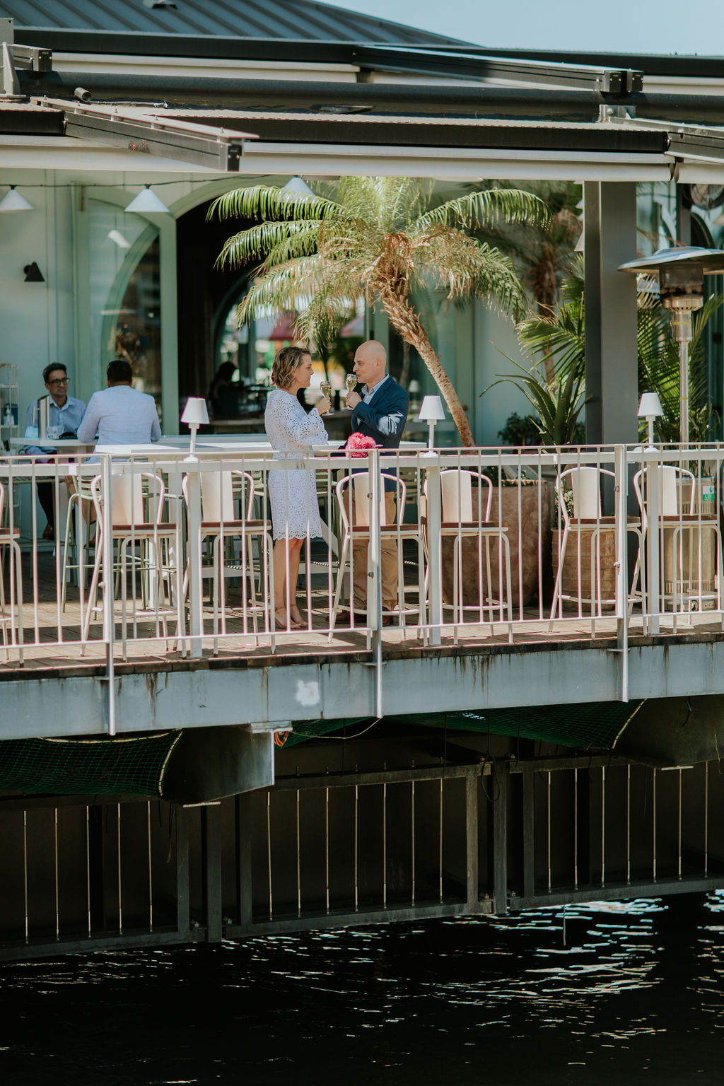 Newlyweds celebrating their Brisbane elopement with drinks at Mr Percival’s under the Story Bridge